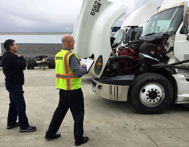 Transervice often has maintenance personnel in the yard to help drivers with pre-trip inspections. - Photo: Transervice