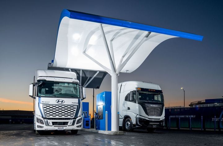 Hyundai and Nikola fuel-cell-electric trucks at a hydrogen refueling station.