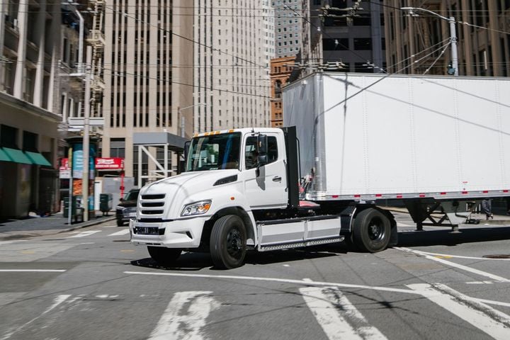 White Tern tractor-trailer navigating urban intersection