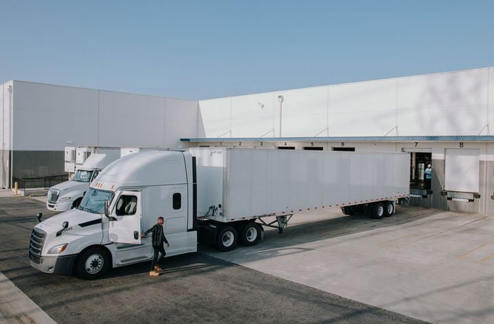 Tractor-trailer backed up to cargo dock