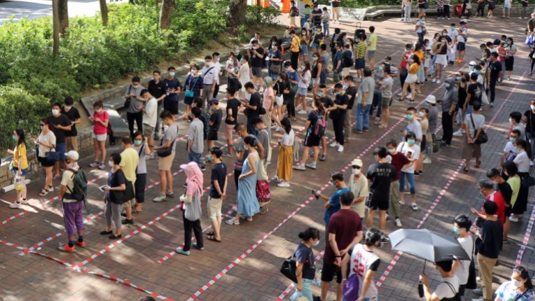 Voters queue up to vote during primary elections aimed for selecting democracy candidates, in Hong Kong