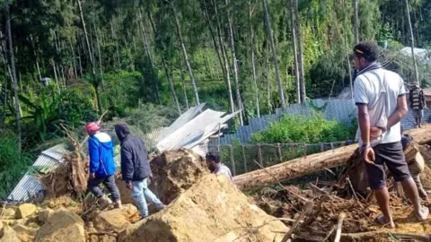 Getty Images People gather at the site of a landslide in Maip Mulitaka in Papua New Guinea's Enga Province on May 24, 2024.