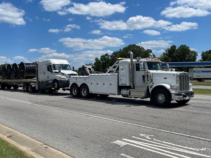 Tractor-trailer being towed.