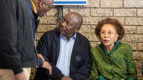 EPA South African President Cyril Ramaphosa (C) sits as he prepares to cast his vote at the Hitekani Primary School in Soweto township, South Africa, 29 May 2024