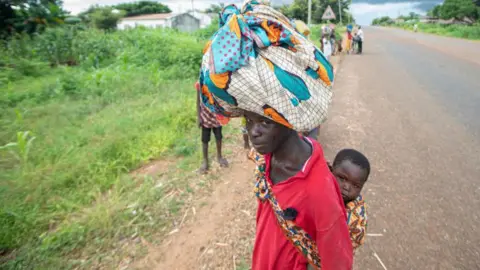 AFP Displaced people from the province of Cabo Delgado walk through the streets of Namapa, Erati district of Nampula, Mozambique on February 27, 2024