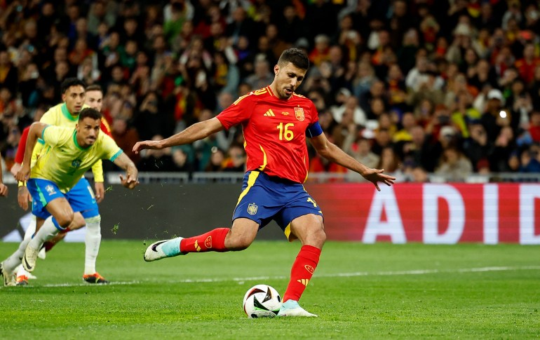 Football player strikes ball during a match.