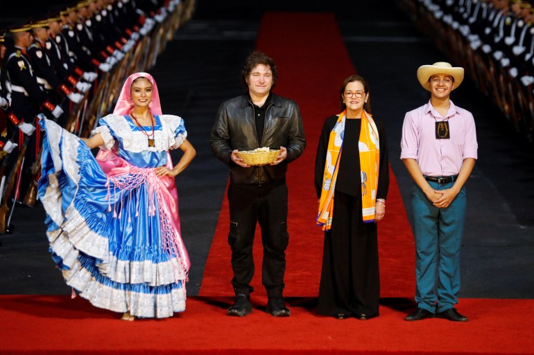 Argentina's President Javier Milei takes part in a welcome ceremony with El Salvador’s Minister of Foreign Affairs Alexandra Hill Tinoco as he arrives to participate in El Salvador's President Nayib Bukele's second term inauguration ceremony, in San Luis Talpa, El Salvador May 31, 2024. REUTERS/Jose Cabezas