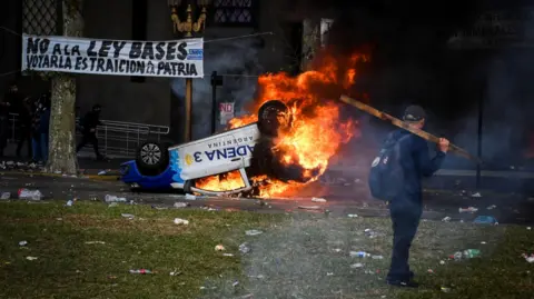 Reuters A car burns during a protest near the National Congress