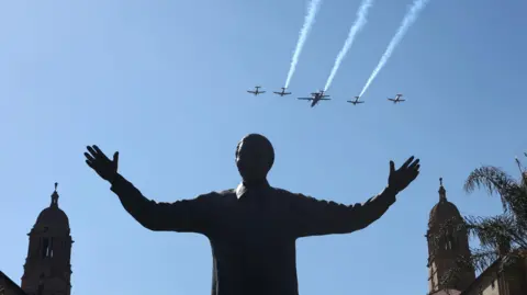 EPA Aircraft perform a fly-by over a statue of former South African president Nelson Mandela