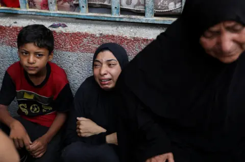 Reuters A woman grieves at the site of an Israeli strike on a UN school in the Nuseirat refugee camp