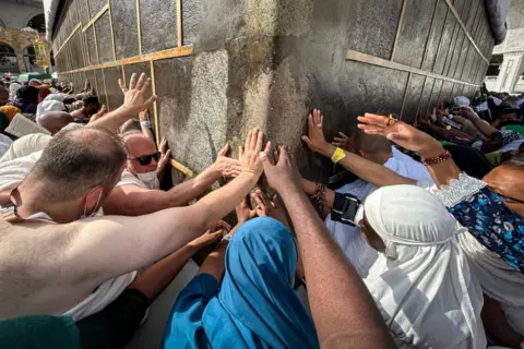 FADEL SENNA/AFP Muslim worshippers touch the Kaaba, Islam's holiest shrine, at the Grand Mosque in Saudi Arabia's holy city of Mecca