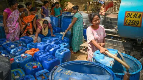 Getty Images NEW DELHI, INDIA - JUNE 6: People fill water from a Delhi Jal Board Tanker amid water scarcity at Anand Parbat on June 6, 2024 in New Delhi, India. (Photo by Sanchit Khanna/Hindustan Times via Getty Images)