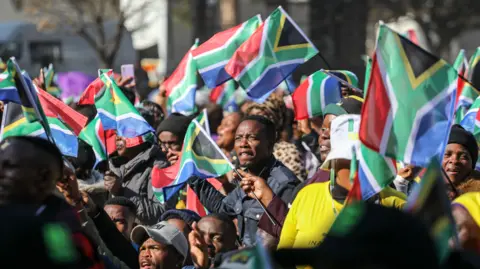 EPA Supporters outside Union Buildings wave South African flags