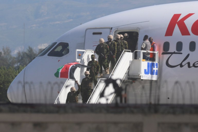 Kenyan police disembark from a plane