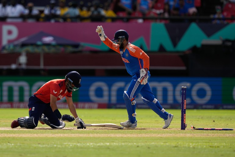 India's wicketkeeper Rishabh Pant, right, celebrates after stumping out England's Moeen Ali, left, during the ICC Men's T20 World Cup second semifinal cricket match between England and India at the Guyana National Stadium in Providence, Guyana, Thursday, June 27, 2024. (AP Photo/Ramon Espinosa)