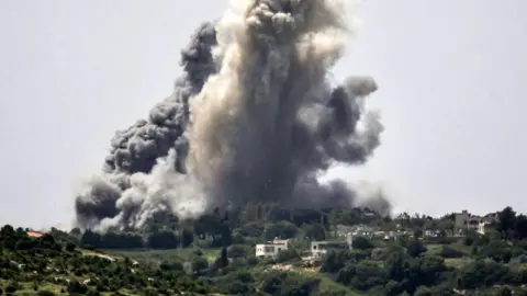 Getty Images Plumes of smoke erupt during Israel’s bombardment of Alma al-Shaab in April 2024 