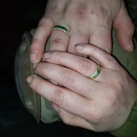 Valeria Subotina Close of Andriy and Valeria's hands with tin-foil rings