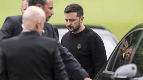 EPA Ukraine's President Volodymyr Zelensky steps toward a limousine after landing in Obbuergen near the Buergenstock Resort, ahead the Summit on Peace in Ukraine, in Stansstad near Lucerne, Switzerland,