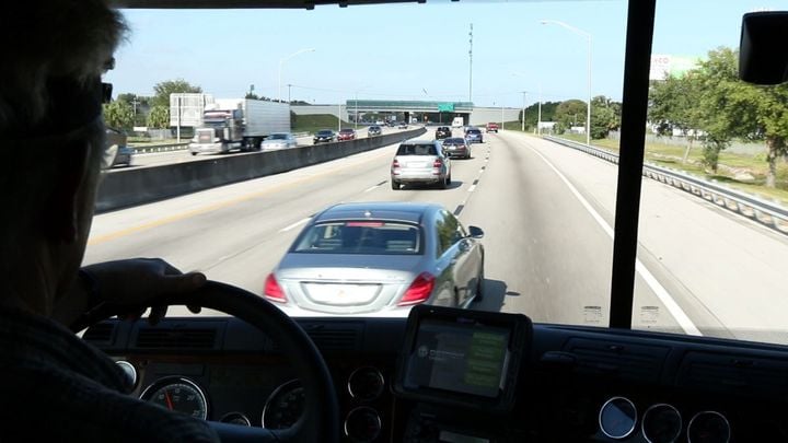 Driver's view from truck cab going down a highway.