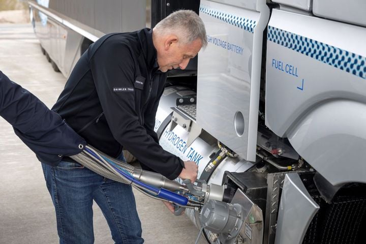 Driver fueling a truck with liquid hydrogen.