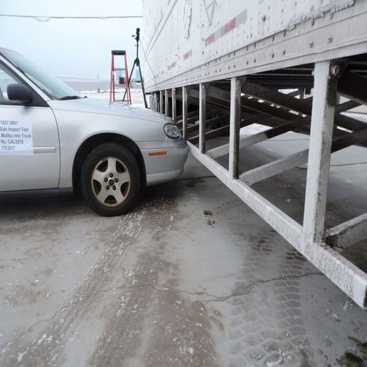 Truck trailer side guard safety barrier and car.