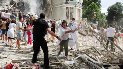 Reuters Staff at the Okhmadyt children's hospital form human chains to move rubble after the attack