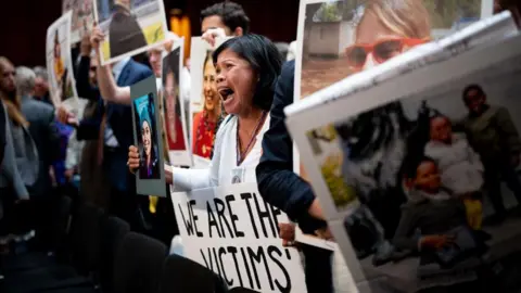 Getty Images Clariss Moore, whose daughter died on a Boeing plane, confronts Boeing boss Dave Calhoun at a hearing in Washington, DC in June