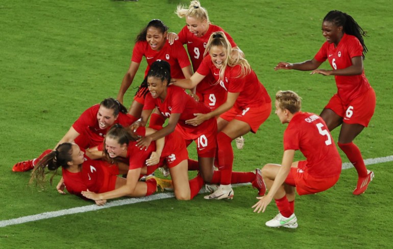 Tokyo 2020 Olympics - Soccer Football - Women - Gold medal match - Sweden v Canada - International Stadium Yokohama, Yokohama, Japan - August 6, 2021. Julia Grosso of Canada celebrates with teammates after scoring the winning penalty in the shootout. REUTERS/Carlos Barria