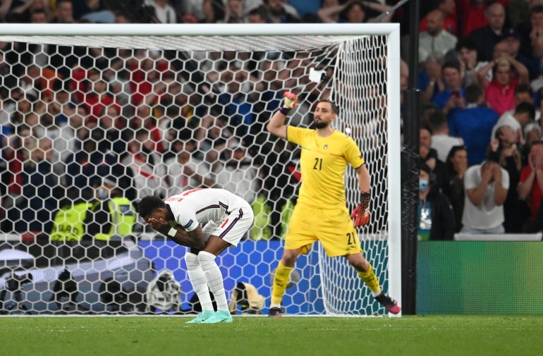 FILE PHOTO: Soccer Football - Euro 2020 - Final - Italy v England - Wembley Stadium, London, Britain - July 11, 2021 England's Marcus Rashford misses a penalty during a penalty shootout as Italy's Gianluigi Donnarumma celebrates Pool via REUTERS/Andy Rain/File Photo