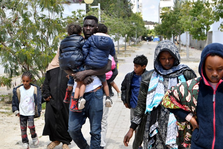 Migrants leave after Tunisian police dismantled a makeshift camp for refugees from sub-Saharan African countries in front of the UNHCR headquarters in Tunis.