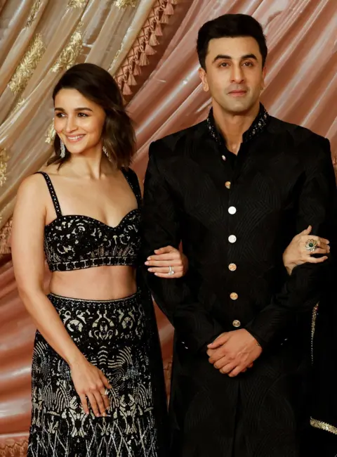 Reuters Indian actors Alia Bhatt and Ranbir Kapoor pose for a picture on the red carpet during the sangeet ceremony of Anant Ambani and Radhika Merchant at Jio World Centre, Mumbai, India, July 5, 2024.