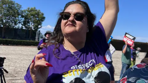 BBC Cynthia “Cyn” Carranza protests with other Disneyland employees outside the park