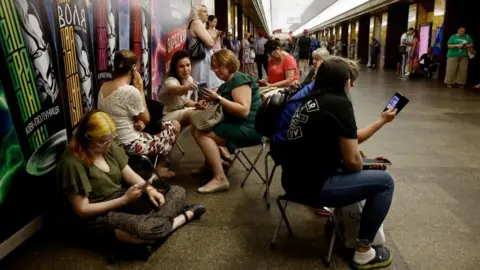 Reuters People taking shelter in the Kyiv metro during the attack