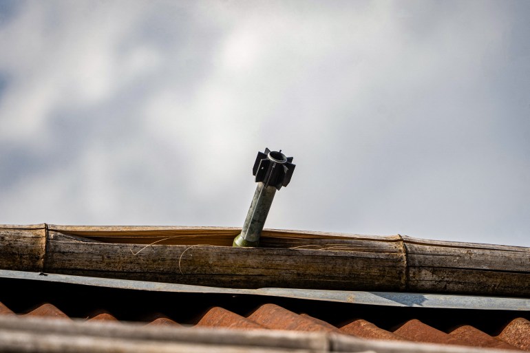 A projectile stuck in the roof of a building