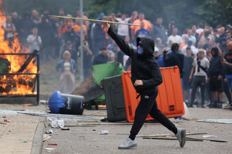 Flames burn as demonstrators take part in an anti-immigration protest, in Rotherham, Britain, August 4, 2024. [Hollie Adams/Reuters]