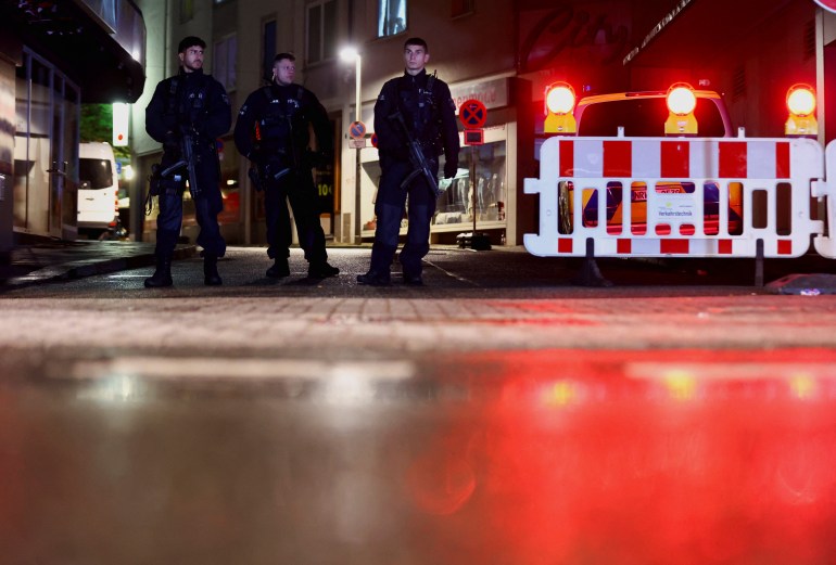 Police officers secure teh area around the stabbing in Solingen.