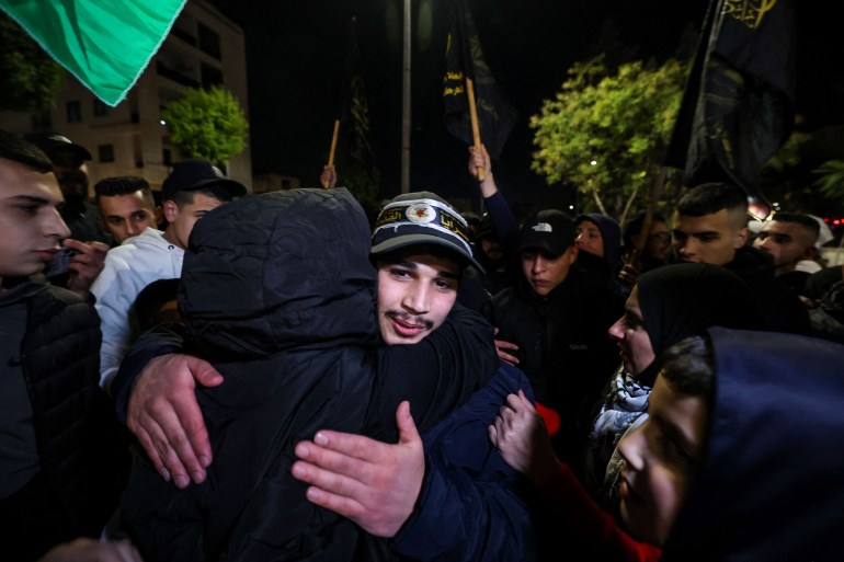 A newly released prisoner (R) hugs a relative during a welcome ceremony following the release of Palestinian prisoners from Israeli jails.