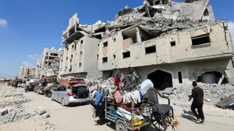 Reuters Displaced Palestinians make their way as they flee following an Israeli evacuation order in Khan Younis