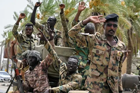 AFP Members of Sudan's armed forces take part in a military parade held on the occasion of Army Day outside the Armed Forces Officers' Club in Port Sudan on 14 August.