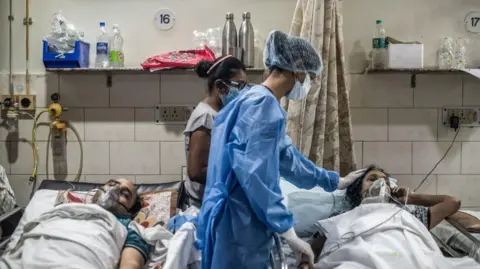 Getty Images Medical staff attend to a patient who has contracted the coronavirus inside the emergency ward of a Covid-19 hospital on May 03, 2021