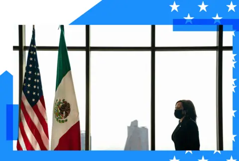 Kamala Harris walks toward two flags - the American flag and Mexican flag 