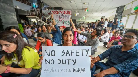 Getty Images Doctors from AIIMS Delhi stage a protest against the alleged Kolkata Doctor Rape case on August 12, 2024 in New Delhi, India.