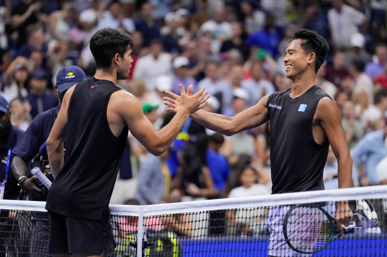 Carlos Alcaraz of Spain, greets Li Tu, of Australia, at the net after winning their first round of the U.S. Open tennis championships, Tuesday, Aug. 27, in New York. 2024. (AP Photo/Matt Rourke)