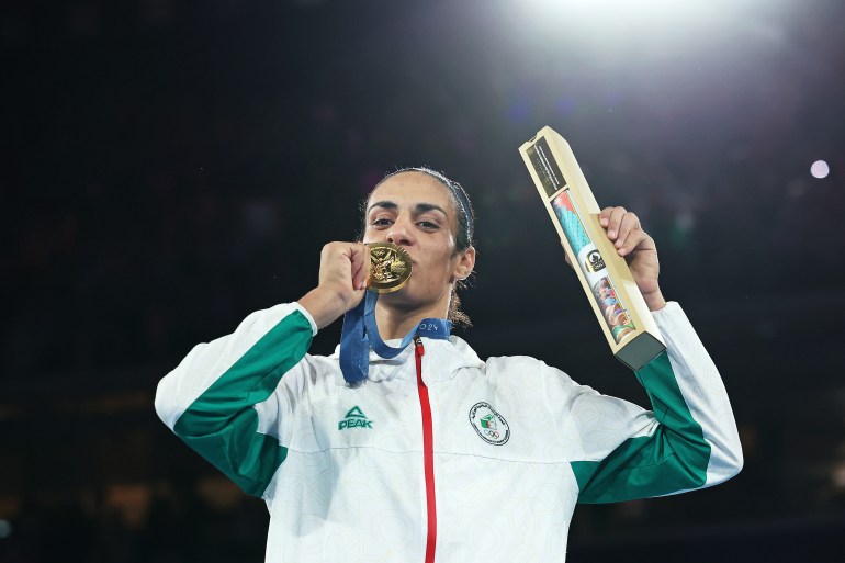 Boxer kisses medal.