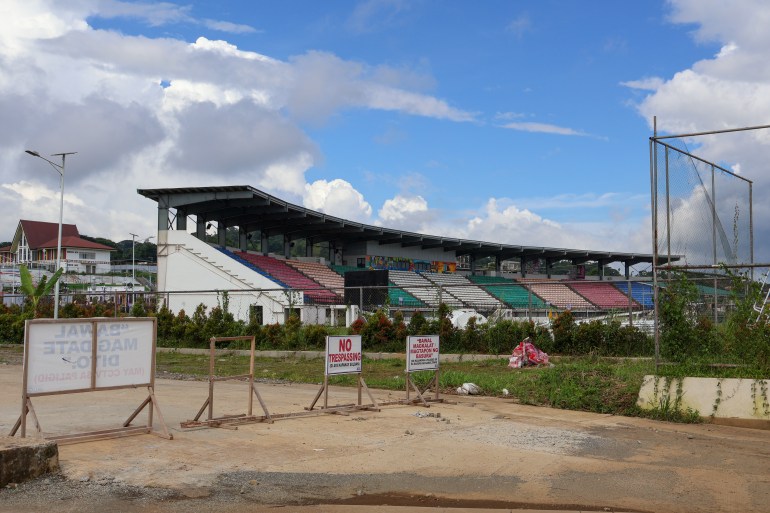 A view of the Sarimanok Sports Stadium. It is deserted. There are signs warning people to keep out