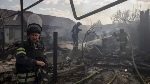 REUTERS/Thomas Peter Emergency workers extinguish a fire that destroyed a private house after a Russian strike on a residential area in Pokrovsk amid Russia's attack on Ukraine, August 3, 2024