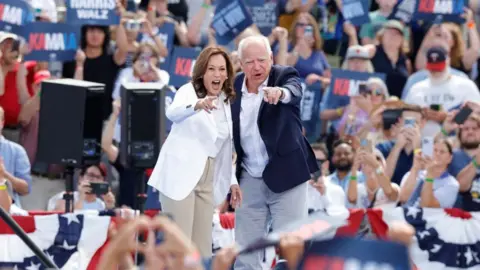 Getty Images Kamala Harris and Tim Walz at a campaign event