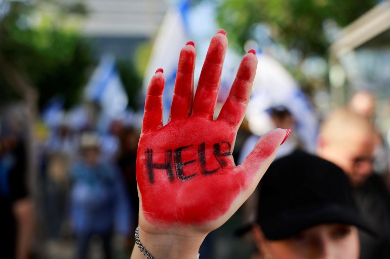 A person holds up their hand, as the families of Israeli hostages held in Gaza since October 7 set out on a protest march from Tel Aviv to Jerusalem in an attempt to pressure Israel's government to make a deal that will release their loved ones, amid Israel-Hamas conflict, in Tel Aviv, Israel July 10, 2024. REUTERS/Ammar Awad