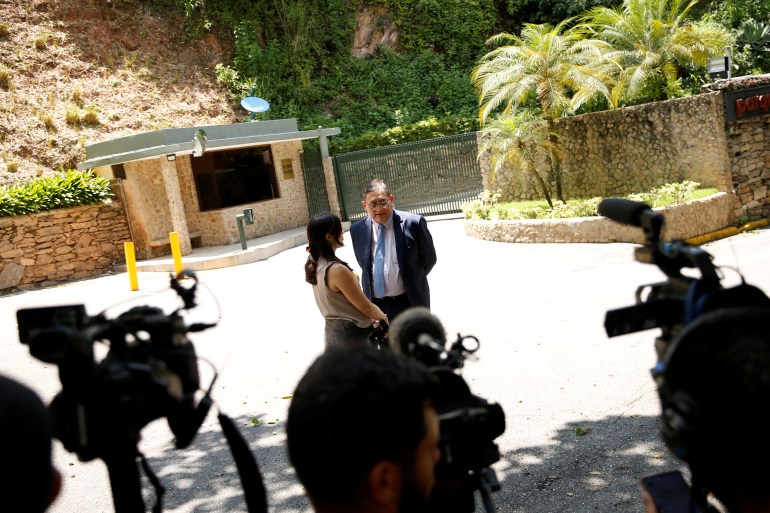 Jose Vicente Haro stands in front of TV cameras outside of Edmundo Gonzalez's home.