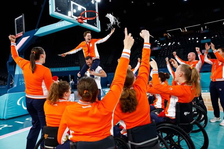 Paris 2024 Paralympics - Wheelchair Basketball - Women's Victory Ceremony - Netherlands vs United States - Bercy Arena, Paris, France - September 8, 2024. Gold medallist Bo Kramer of Netherlands cuts the net as she celebrates with teammates REUTERS/Carlos Garcia Rawlins